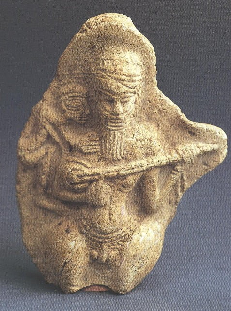 Achaemenid era carving of a Persian man playing a sitar like instrument, roughly 2500 years ago