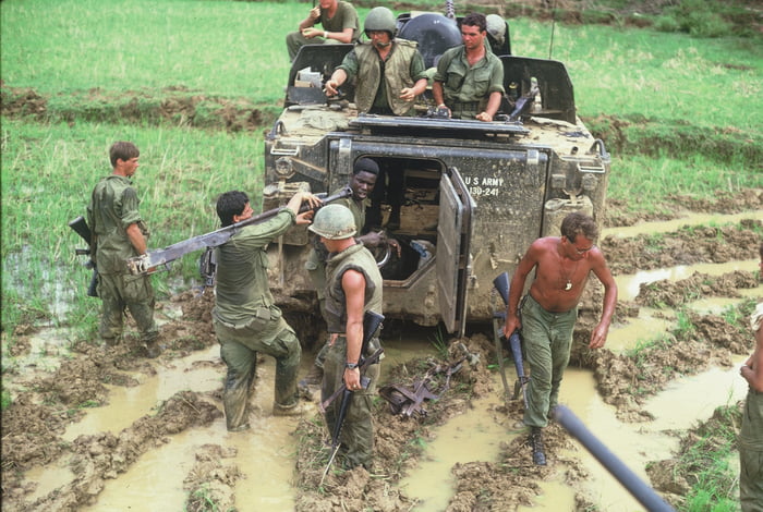 American GIs trying to free an M113 APC stuck in the mud, Vietnam war