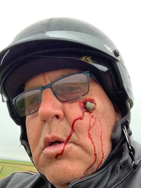 Rock to the face on a motorcycle